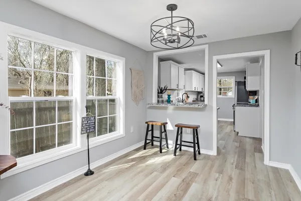 a view of a dining room with furniture window and wooden floor