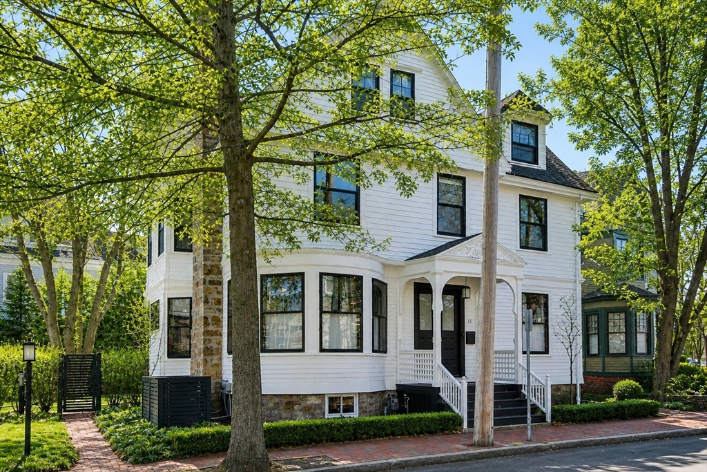 12 Martin Street Cambridge, MA 02138 - Photo 1 of 38 a view of a white house with large windows and a tree