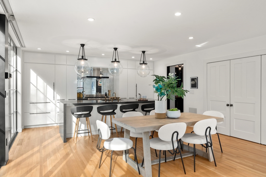 12 Martin Street Cambridge, MA 02138 - Photo 11 of 38 a kitchen with stainless steel appliances kitchen island granite countertop a dining table chairs and refrigerator