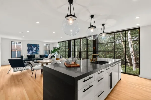 a open kitchen with stainless steel appliances granite countertop a sink counter space and a table