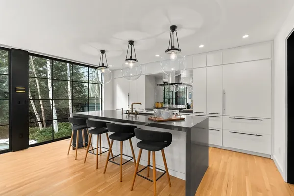 a kitchen with a table chairs and wooden floor