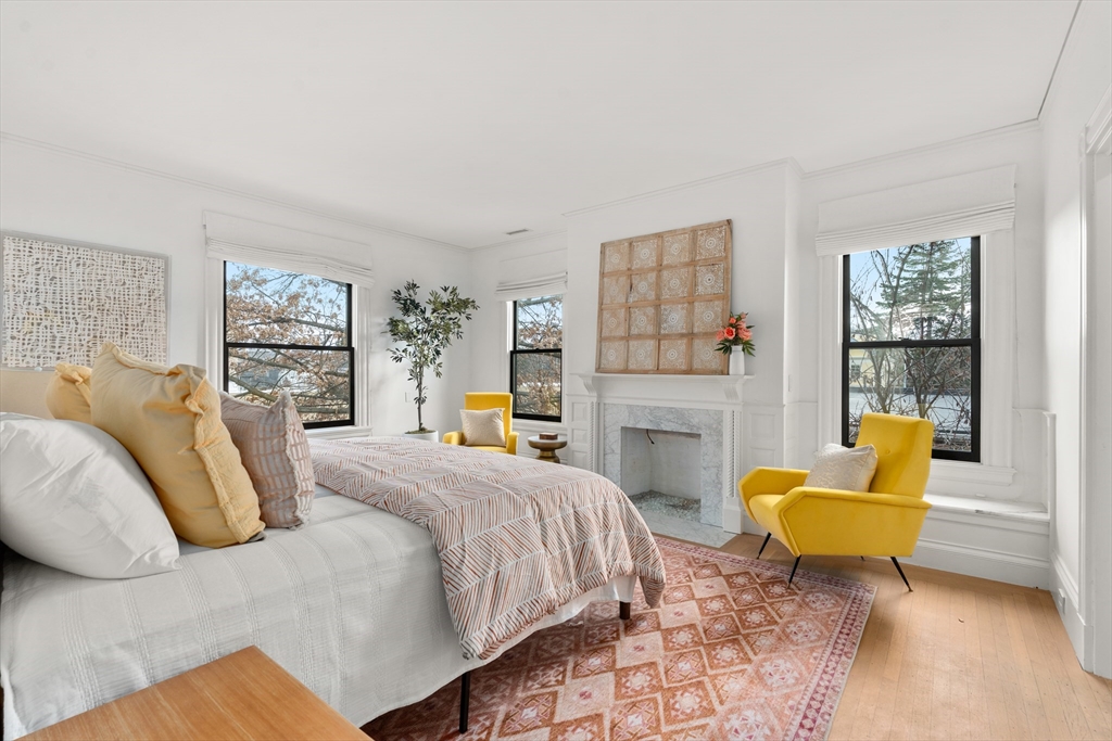 12 Martin Street Cambridge, MA 02138 - Photo 19 of 38 a spacious bedroom with a bed a couch and a window