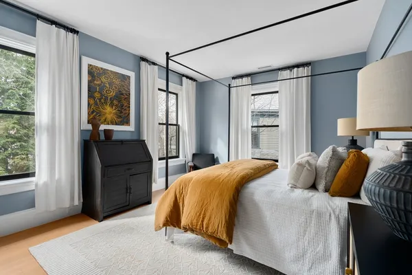 a bedroom with a bed and wooden floor