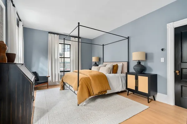 a bedroom with a bed window and table