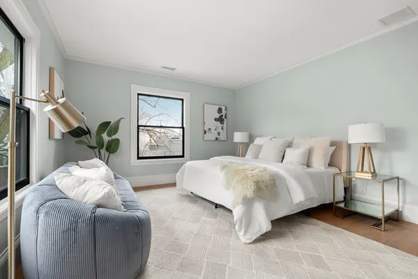 a spacious bedroom with two beds and a window