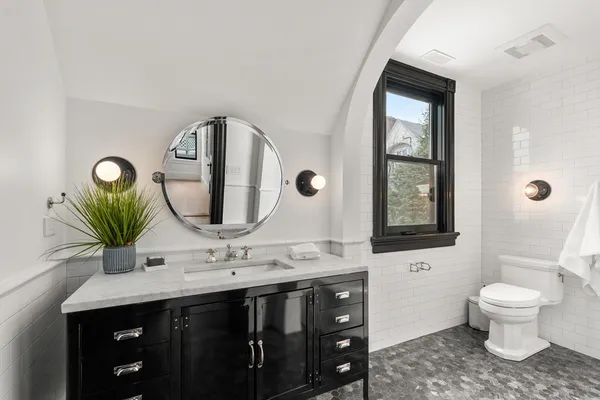 a bathroom with a double vanity sink toilet and a mirror