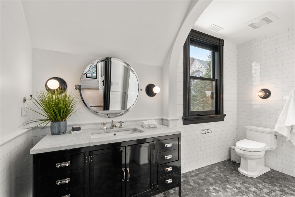 12 Martin Street Cambridge, MA 02138 - Photo 26 of 38 a bathroom with a double vanity sink toilet and a mirror