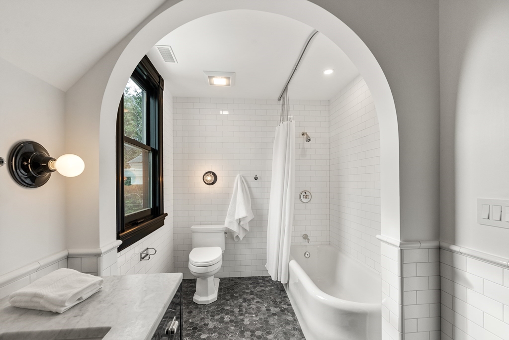 12 Martin Street Cambridge, MA 02138 - Photo 27 of 38 a bathroom with a sink a toilet and a large mirror