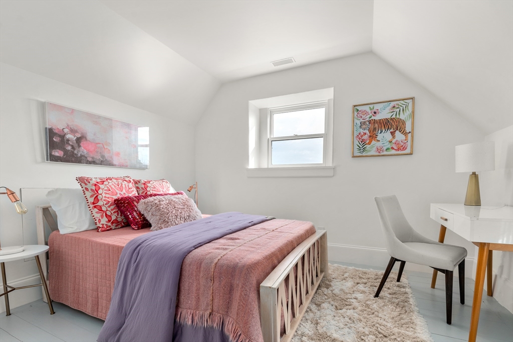 12 Martin Street Cambridge, MA 02138 - Photo 28 of 38 a bedroom with a large bed and a chair