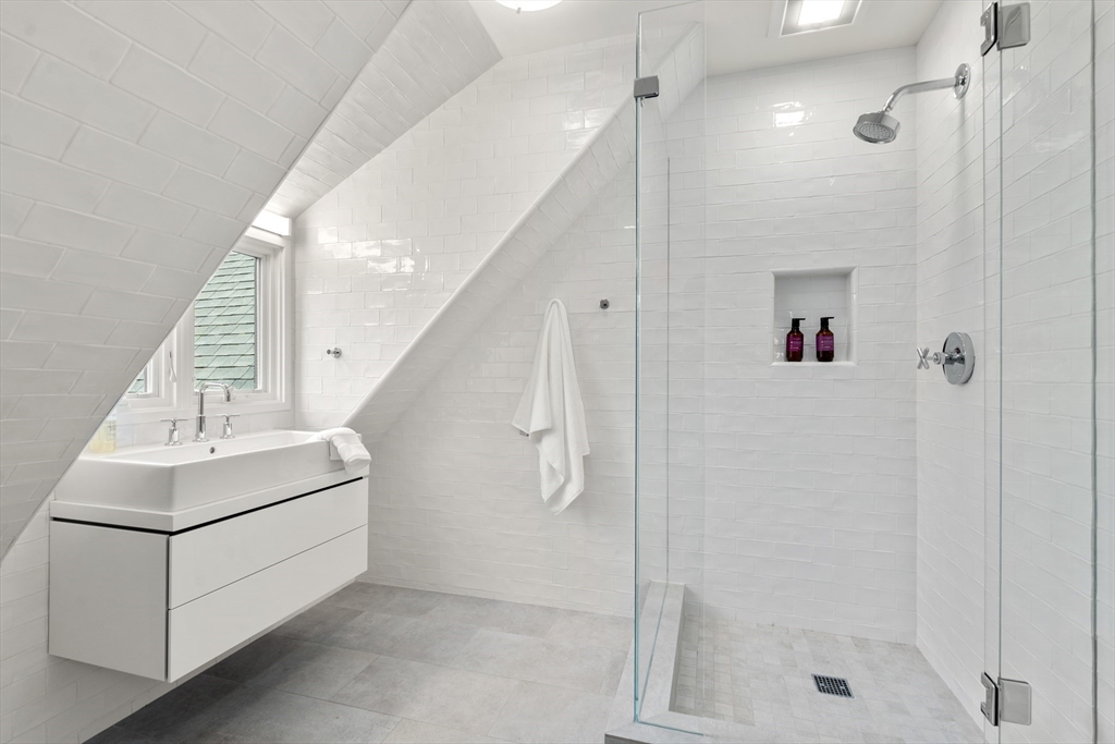 12 Martin Street Cambridge, MA 02138 - Photo 29 of 38 a bathroom with a shower a sink and a mirror