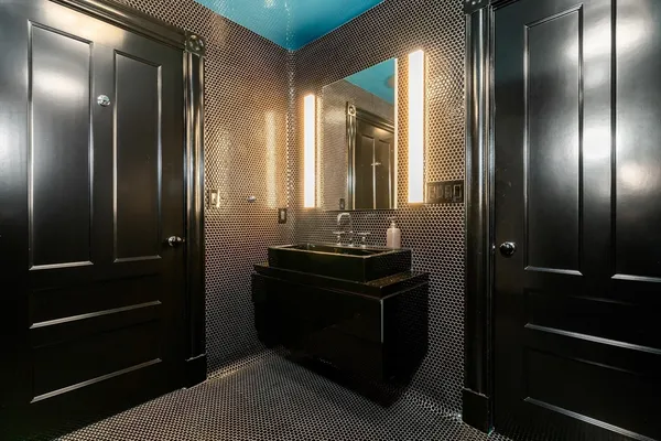a bathroom with a double vanity sink and a mirror