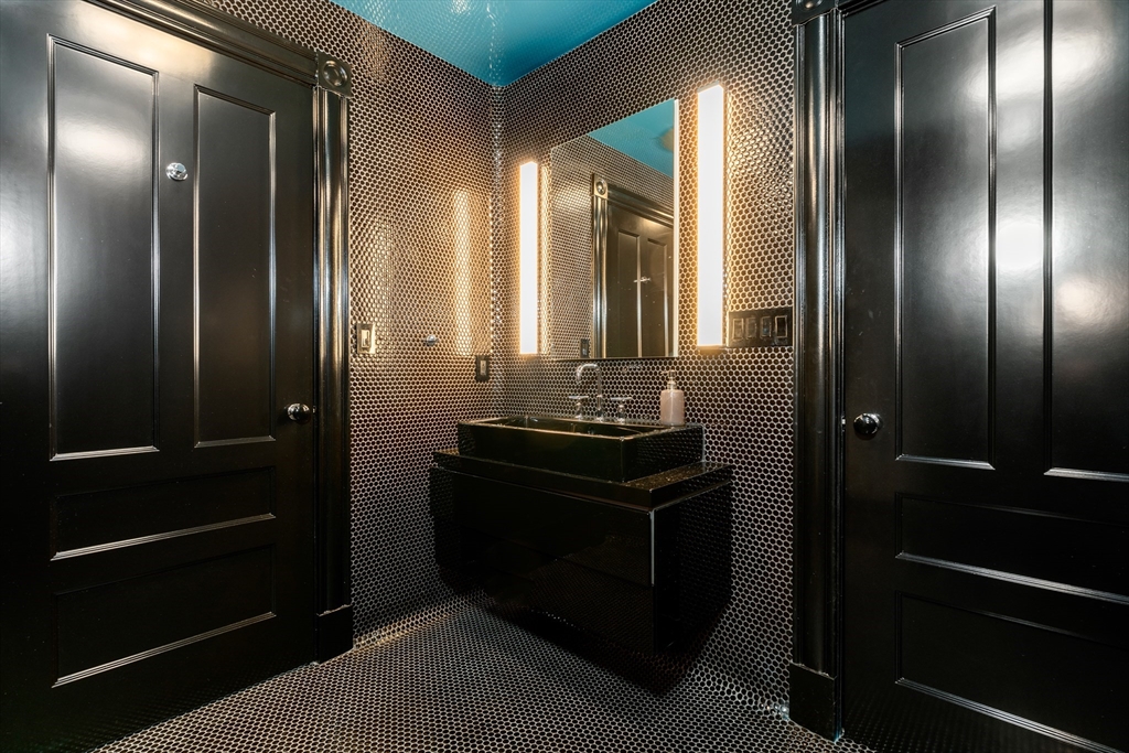 12 Martin Street Cambridge, MA 02138 - Photo 31 of 38 a bathroom with a double vanity sink and a mirror