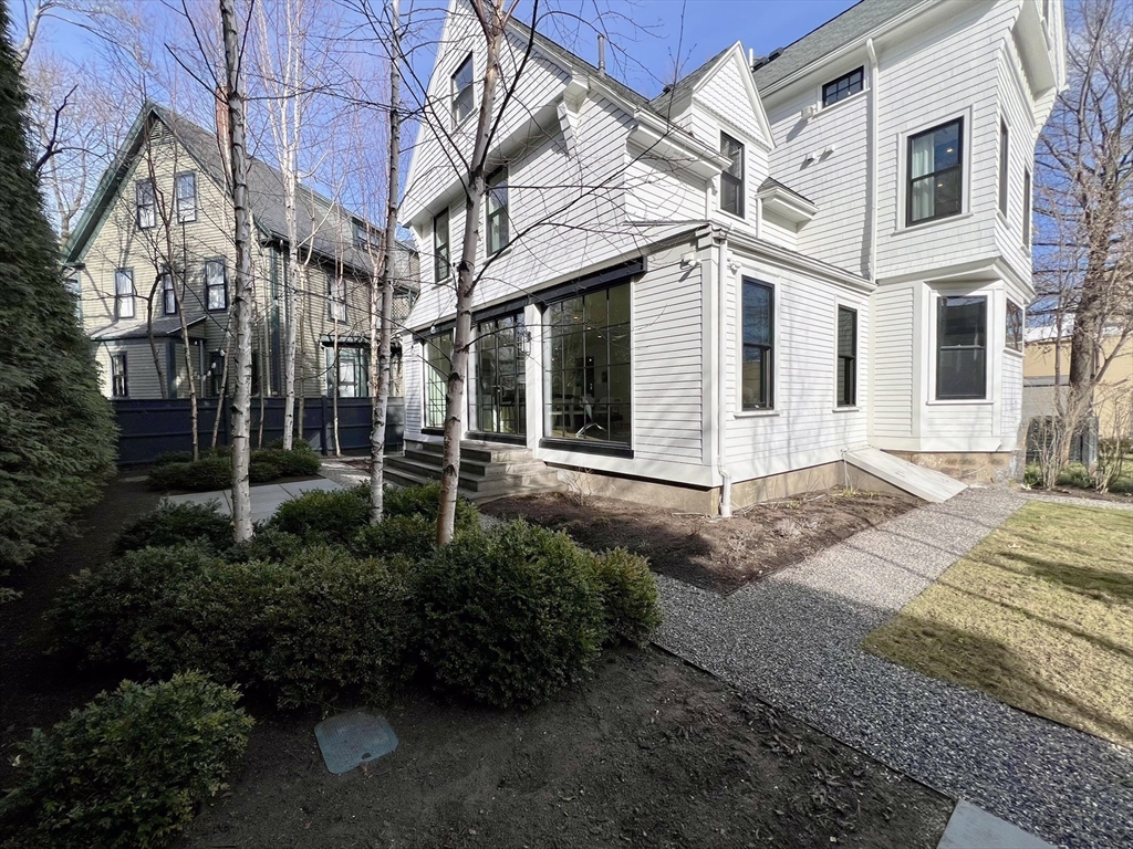 12 Martin Street Cambridge, MA 02138 - Photo 35 of 38 a view of a white house with a small yard and plants