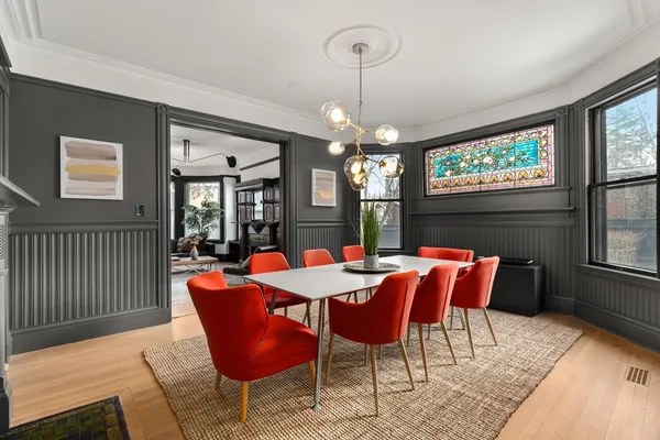 a dining room with furniture a chandelier and window