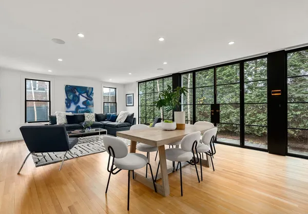 a view of a dining room with furniture window and wooden floor