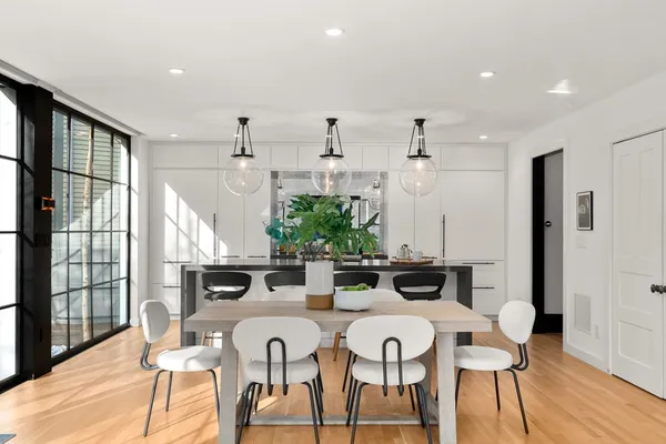 a view of a dining room with furniture window and wooden floor