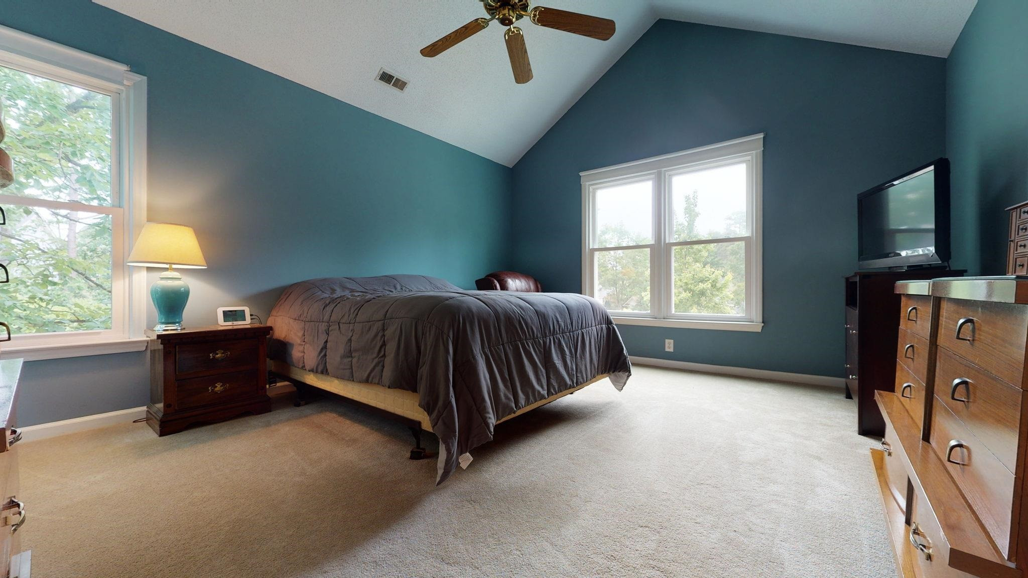 12205 Harcourt Drive Raleigh, NC 27613 - Photo 18 of 35 The generously sized owners' suite is enhanced by the dramatic vaulted ceiling.