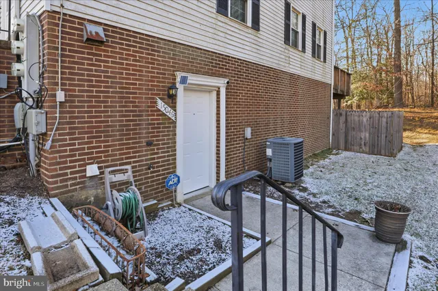 a view of a pathway with a brick wall