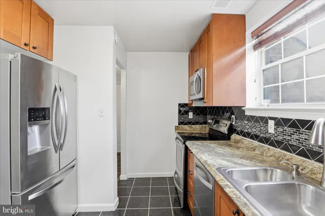 a kitchen with a sink and a refrigerator
