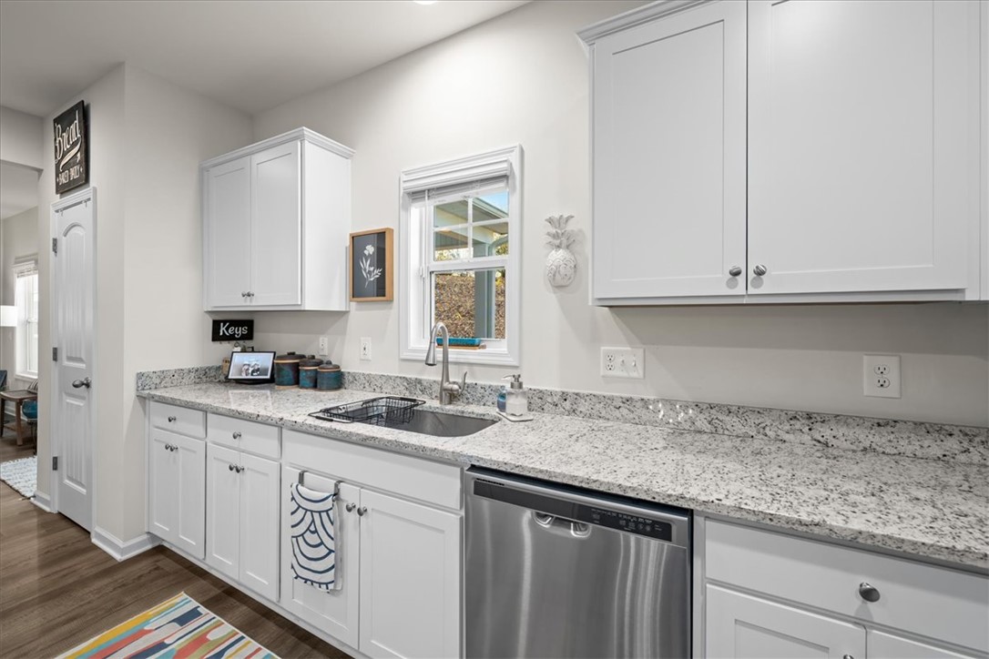 216 Carvel Trail Seneca, SC 29678 - Photo 14 of 46 This modern kitchen features bright white cabinetry and speckled granite countertops.