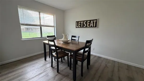 a view of a dining room with furniture window and wooden floor