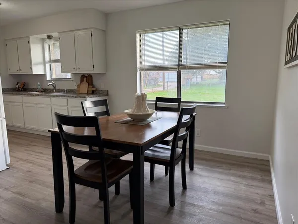 a view of a dining room with furniture and window