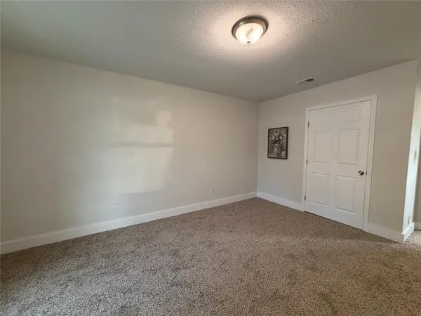 an empty room with a empty space and windows