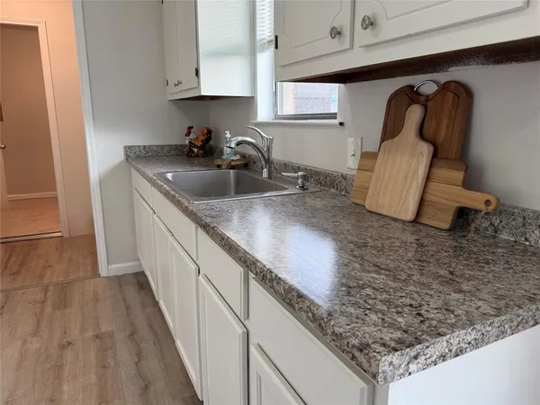 a kitchen with sink and cabinets