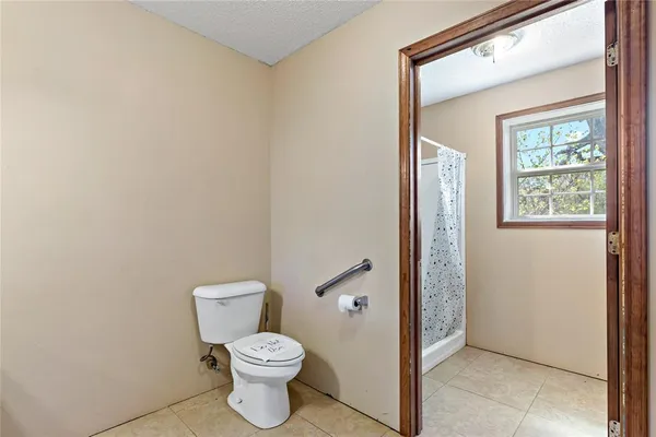 a bathroom with a toilet and a shower