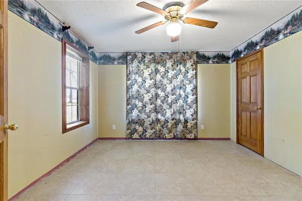 a view of a livingroom with a ceiling fan and window