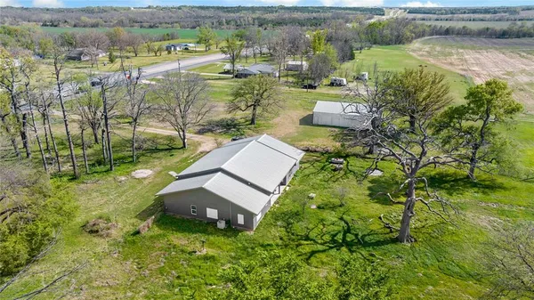 an aerial view of a house with a yard