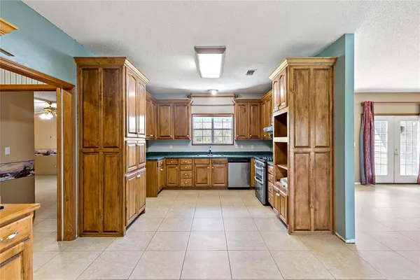 a large kitchen with a refrigerator and a sink