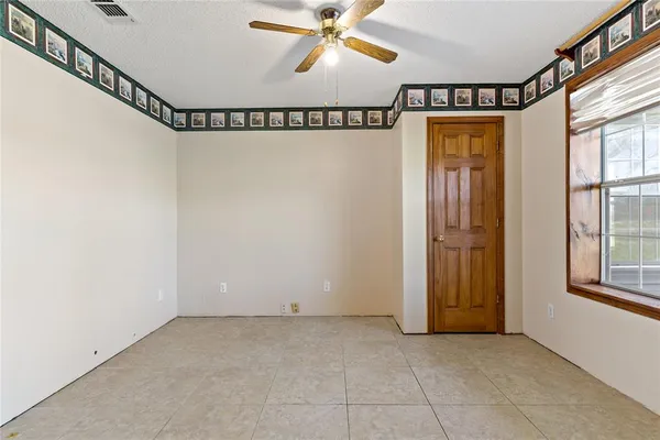 a view of a room with window and a chandelier