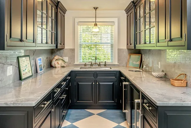 a kitchen with granite countertop a sink a stove and cabinets