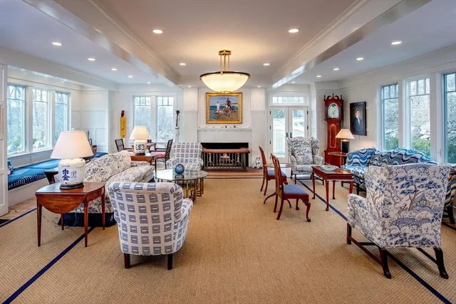 a living room with fireplace furniture and a large window