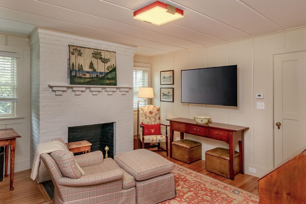 23 University Lane Manchester, MA 01944 - Photo 15 of 40 a living room with furniture and a flat screen tv