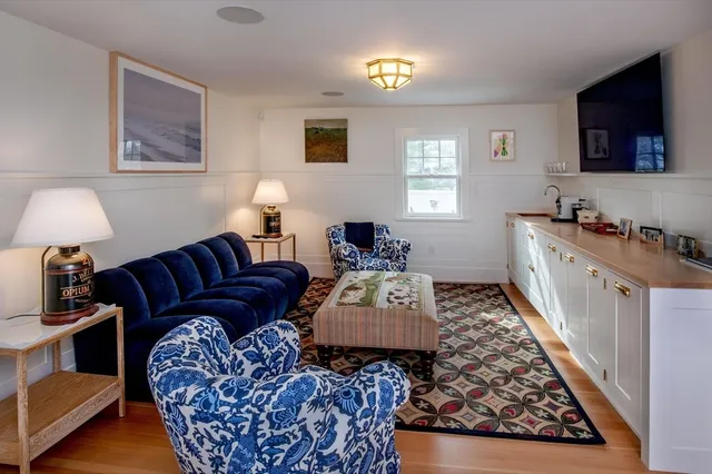 a living room with furniture rug and a window