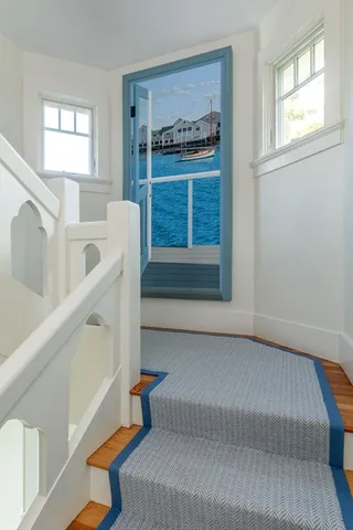 a kitchen with white cabinets and window