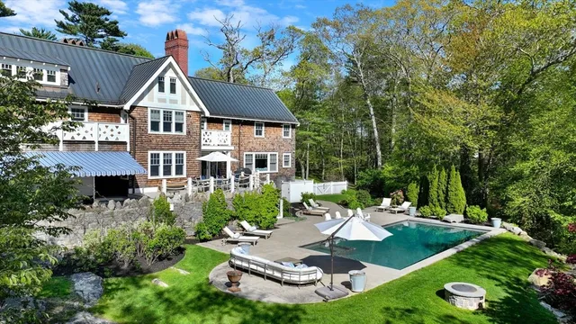 a view of a house with swimming pool and garden