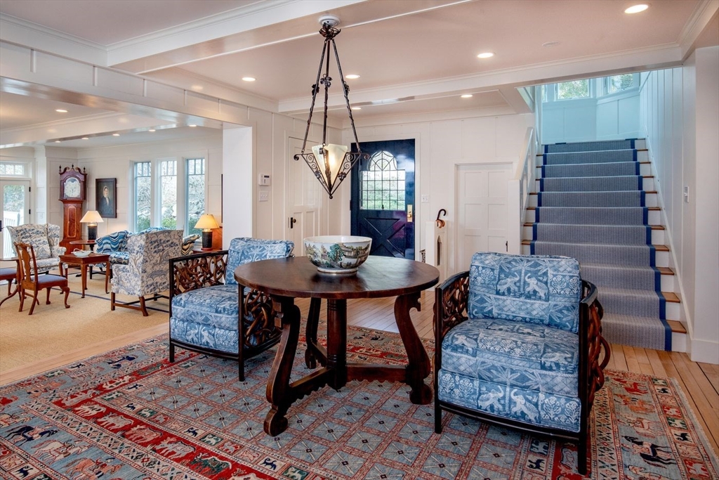 23 University Lane Manchester, MA 01944 - Photo 8 of 40 a living room with furniture and a chandelier