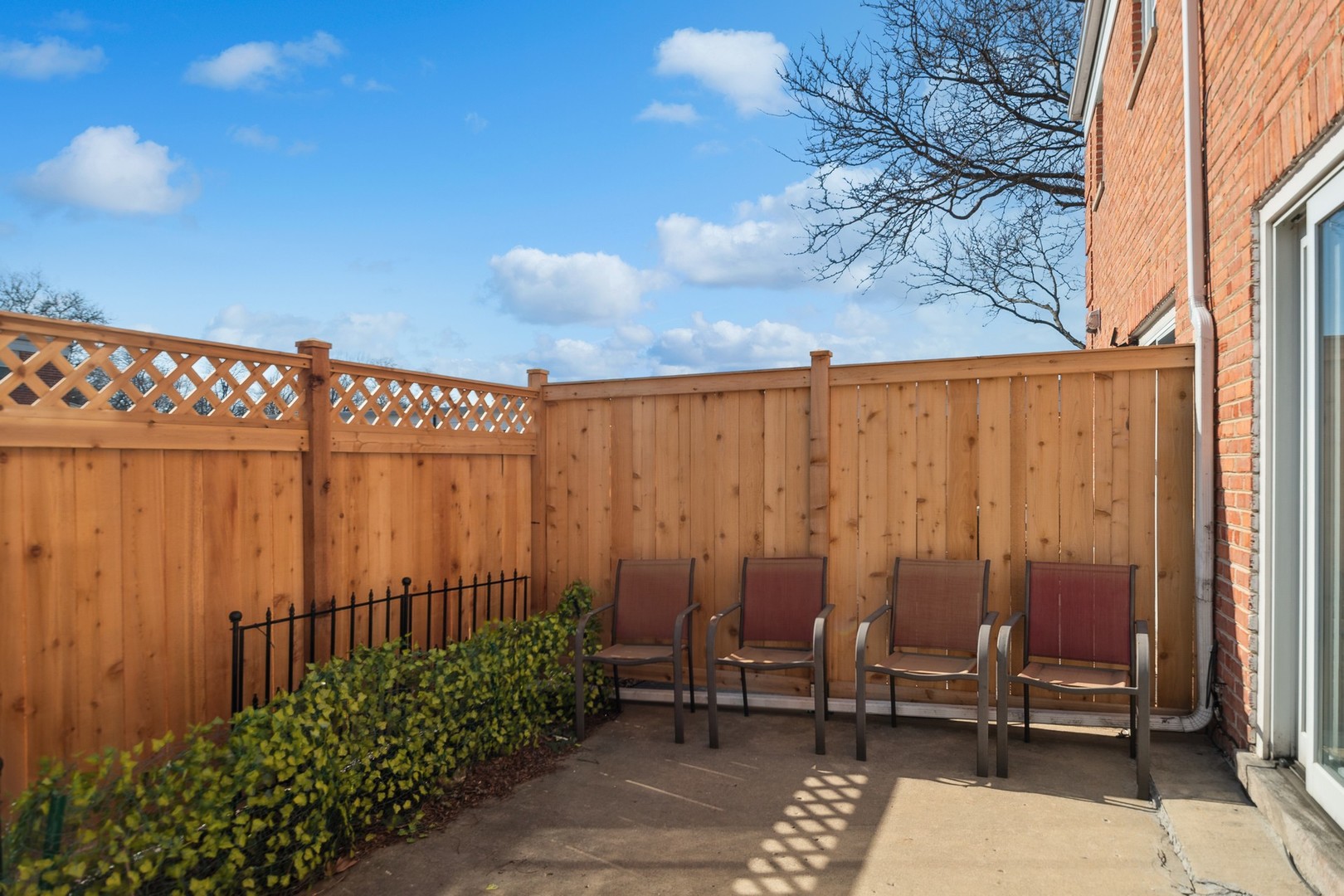 2148 Rugen Road, Unit D Glenview, IL 60026 - Photo 14 of 19 a backyard of a house with chairs and wooden fence