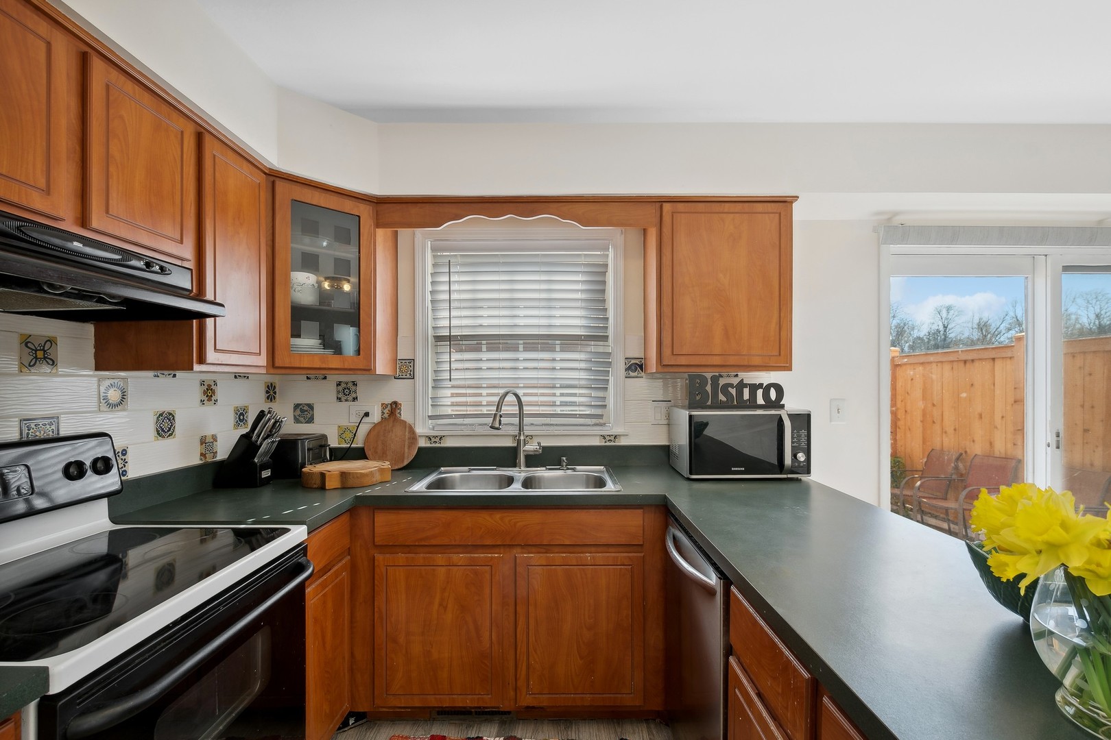 2148 Rugen Road, Unit D Glenview, IL 60026 - Photo 5 of 19 a kitchen with stainless steel appliances granite countertop sink stove and cabinets