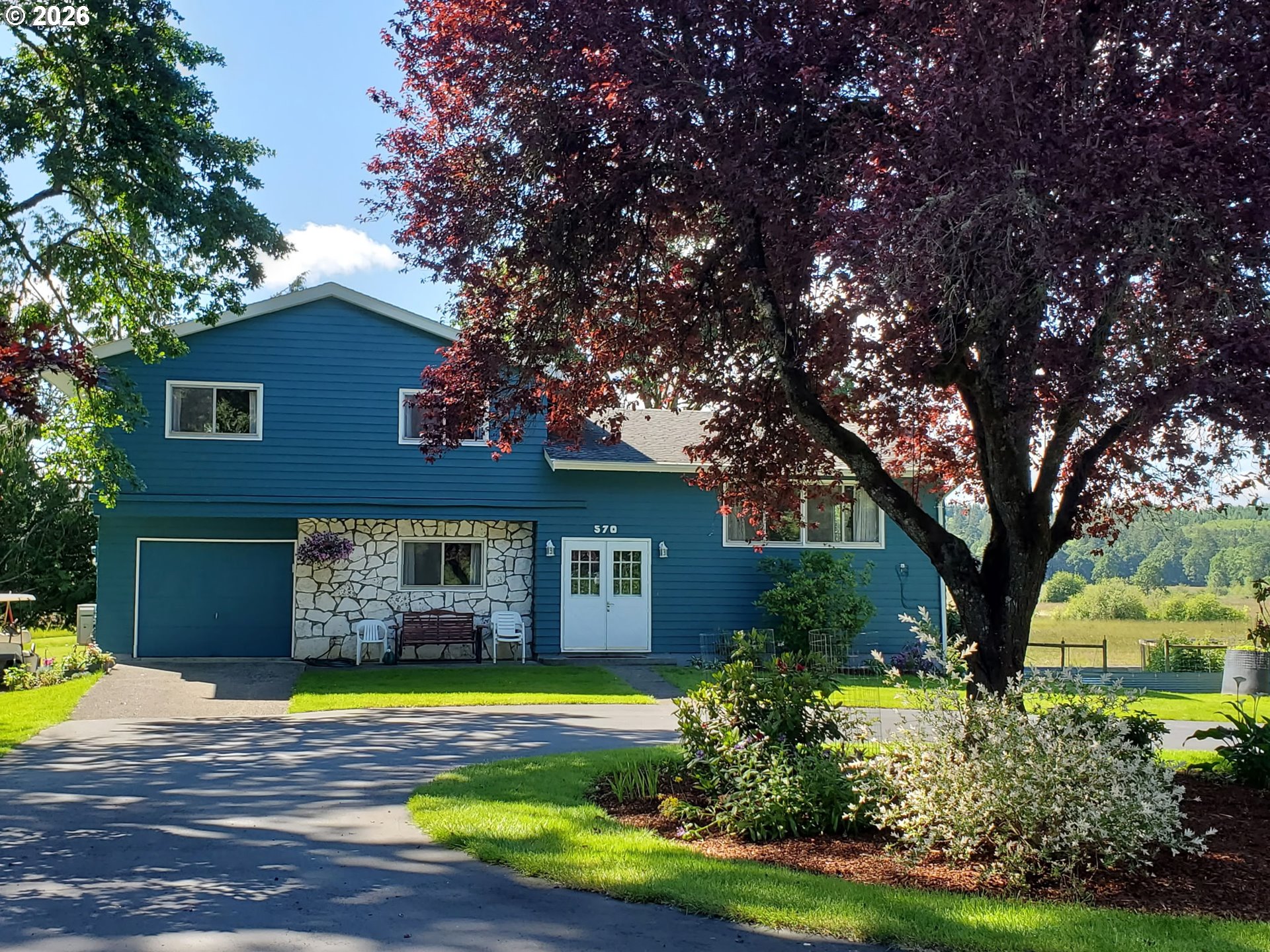 a view of a house with swimming pool and trees