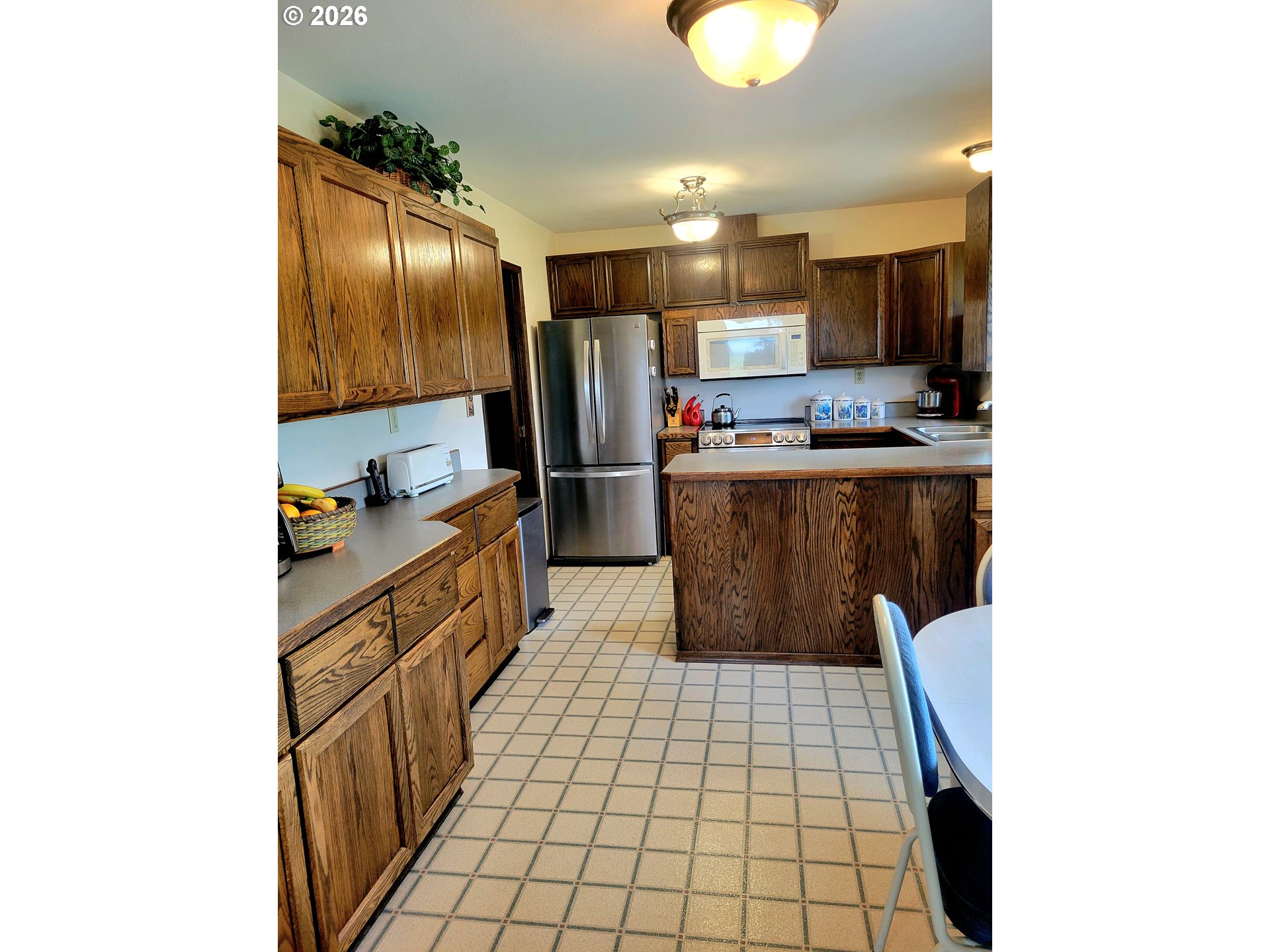570 Drews Prairie Road Winlock, WA 98596 - Photo 23 of 41 a kitchen with stainless steel appliances a refrigerator and microwave
