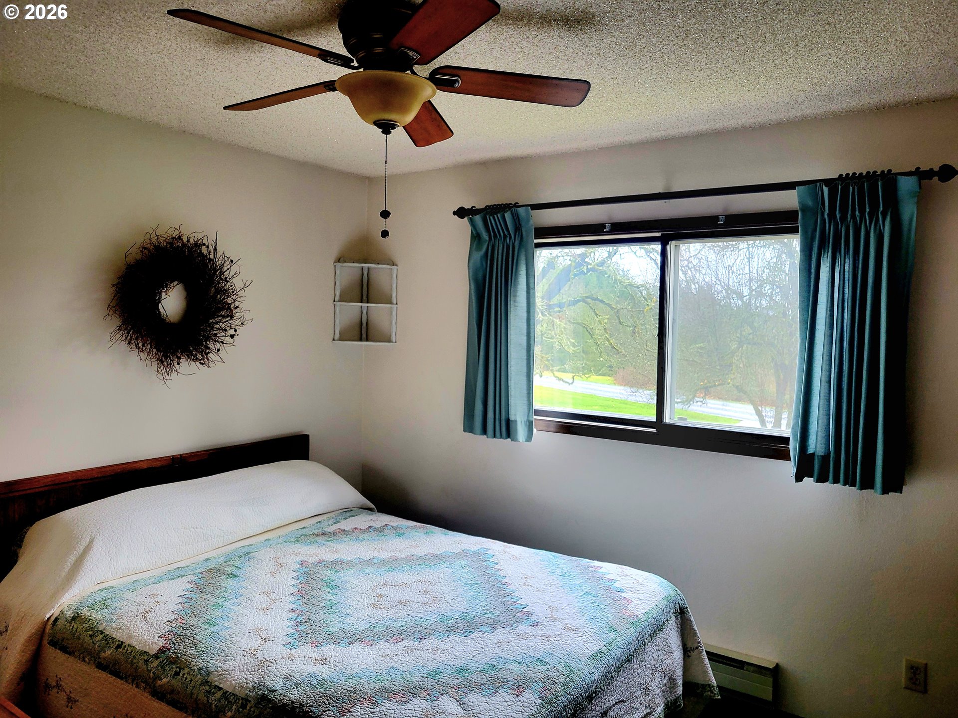570 Drews Prairie Road Winlock, WA 98596 - Photo 29 of 41 a bedroom with a bed and a large window