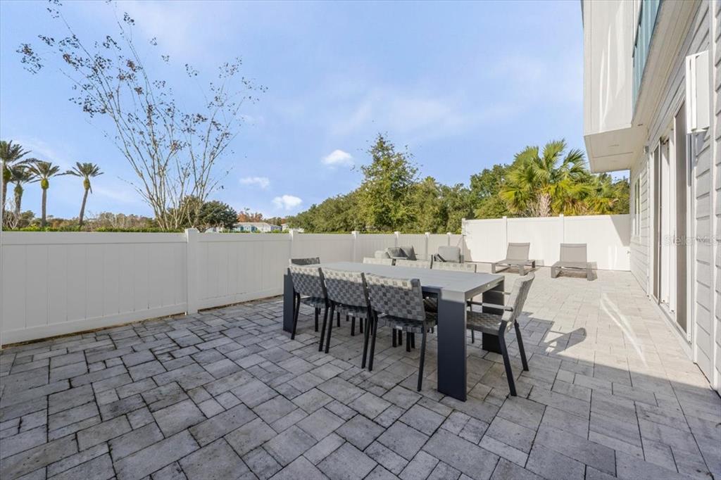 7770 Sandy Ridge Drive, Unit 144 Reunion, FL 34747 - Photo 13 of 22 a view of a dining tables and chairs in a patio