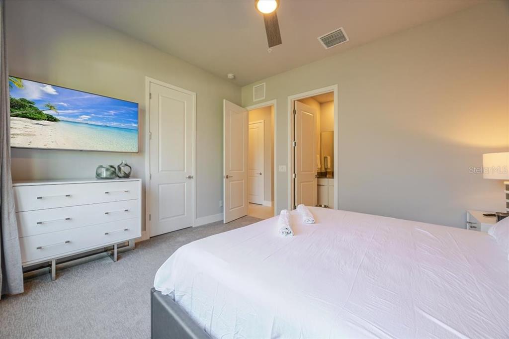 7770 Sandy Ridge Drive, Unit 144 Reunion, FL 34747 - Photo 18 of 22 a bedroom with a bed and cabinets