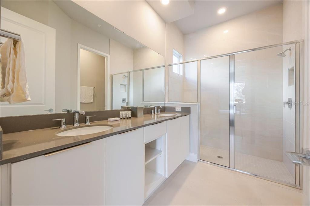 7770 Sandy Ridge Drive, Unit 144 Reunion, FL 34747 - Photo 19 of 22 a bathroom with a double vanity sink and mirror