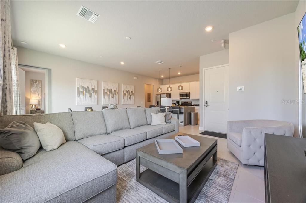 7770 Sandy Ridge Drive, Unit 144 Reunion, FL 34747 - Photo 8 of 22 a living room with furniture and view of kitchen