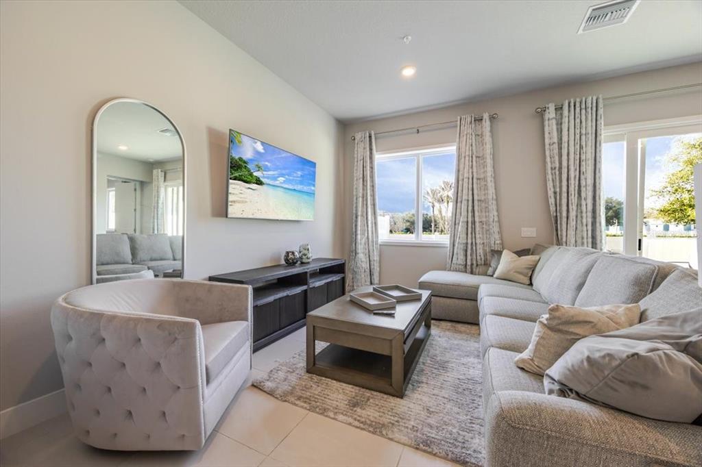 7770 Sandy Ridge Drive, Unit 144 Reunion, FL 34747 - Photo 9 of 22 a living room with furniture and a large window